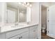 Bright bathroom showcasing double sinks, a quartz countertop, and a walk-in shower at 314 Embers Ln, Clover, SC 29710
