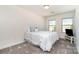 Cozy bedroom featuring two windows, neutral walls, and a comfortable queen bed at 314 Embers Ln, Clover, SC 29710