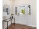 Inviting entryway with hardwood floors, front door with sidelights and a stylish console table with a modern lamp at 314 Embers Ln, Clover, SC 29710