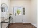 Bright entryway with hardwood floors, stylish console table with modern decor, and a front door with sidelights at 314 Embers Ln, Clover, SC 29710