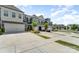 Street view of townhomes with well-maintained landscaping and ample parking space, complemented by beautiful blue skies at 314 Embers Ln, Clover, SC 29710