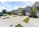 Street view of a row of townhomes with manicured lawns and ample parking in a well-maintained community at 314 Embers Ln, Clover, SC 29710