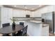 Modern kitchen with white cabinetry, stainless steel appliances, and granite countertops at 314 Embers Ln, Clover, SC 29710