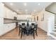 Modern kitchen with white cabinets, stainless steel appliances, and a dining area at 314 Embers Ln, Clover, SC 29710