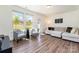 Sunlit living room features hardwood floors, stylish seating, and large windows providing plenty of natural light at 314 Embers Ln, Clover, SC 29710