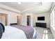 Open main bedroom featuring an ensuite bathroom, a walk-in closet, and a television at 314 Embers Ln, Clover, SC 29710