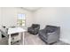 Bright office featuring comfortable gray seating, a white desk, and a window at 314 Embers Ln, Clover, SC 29710