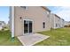 Exterior view of the home with a patio and sliding glass door to the backyard at 3535 Cramer Creek Dr, Gastonia, NC 28056