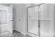 Modern bathroom with glass shower and tiled floor with doorways visible at 3535 Cramer Creek Dr, Gastonia, NC 28056