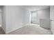 Cozy loft area with carpeted floors, large window, and white trim details at 3535 Cramer Creek Dr, Gastonia, NC 28056