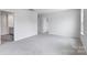 Large bedroom with carpet flooring, white walls, natural light, and two doorways at 3535 Cramer Creek Dr, Gastonia, NC 28056
