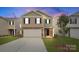 Charming two-story home with attached garage and manicured lawn at 3535 Cramer Creek Dr, Gastonia, NC 28056
