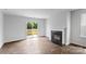 Bright living room features a fireplace, wood floors, and sliding glass doors to backyard at 3535 Cramer Creek Dr, Gastonia, NC 28056