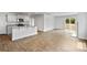 Open-concept living area with modern kitchen island and sliding doors to outdoor space at 3535 Cramer Creek Dr, Gastonia, NC 28056