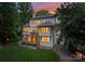 An exterior view of the rear of the home, showing the deck, patio, and yard at 3933 Ayrshire Pl, Charlotte, NC 28210