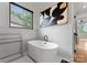 Modern bathroom featuring a freestanding tub, art, window, and tile walls, creating a bright and relaxing space at 3933 Ayrshire Pl, Charlotte, NC 28210