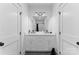 Updated bathroom boasts dual sinks, modern fixtures, and a large mirror for a sleek design at 3933 Ayrshire Pl, Charlotte, NC 28210