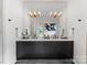 Modern bathroom showcasing a large vanity with double sinks, mirrors, and elegant lighting fixtures at 3933 Ayrshire Pl, Charlotte, NC 28210