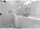 Modern bathroom features glass shower doors, sleek fixtures and a white vanity at 3933 Ayrshire Pl, Charlotte, NC 28210
