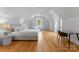 Bright bedroom features hardwood floors, a cozy sitting area, and an abundance of natural light at 3933 Ayrshire Pl, Charlotte, NC 28210
