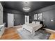 Bedroom featuring a black accent wall, hardwood floors, and plenty of natural light at 3933 Ayrshire Pl, Charlotte, NC 28210