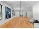 Spacious room featuring a hardwood floor, art, and multiple windows, creating a bright and airy space at 3933 Ayrshire Pl, Charlotte, NC 28210