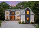 Stunning two-story home features a modern design, well-manicured landscaping, and a spacious driveway for easy parking at 3933 Ayrshire Pl, Charlotte, NC 28210