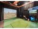 This is an indoor golf simulator, with projector, screen, hitting area and monitor showing golf course information at 3933 Ayrshire Pl, Charlotte, NC 28210