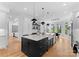 Gourmet kitchen with oversized island, modern pendant lights, and seating at 3933 Ayrshire Pl, Charlotte, NC 28210