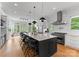 Open kitchen with a large island, stainless steel appliances, and seating for entertaining at 3933 Ayrshire Pl, Charlotte, NC 28210
