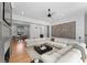 Spacious living room featuring a sectional sofa, hardwood floors, stylish decor, and an open concept design at 3933 Ayrshire Pl, Charlotte, NC 28210