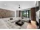 Open living room features large sectional, hardwood floors, modern art, and patio access, perfect for relaxing at 3933 Ayrshire Pl, Charlotte, NC 28210