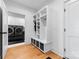 Bright mudroom featuring built-in storage, bench, and adjacent laundry room with modern washer and dryer at 3933 Ayrshire Pl, Charlotte, NC 28210