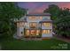 Expansive backyard features covered patio with stone accents, upper deck, and lush lawn, perfect for outdoor living at 3933 Ayrshire Pl, Charlotte, NC 28210