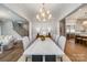 Elegant dining room boasts a large table with seating for eight and modern light fixtures at 4021 Nettie Ct # 7, Charlotte, NC 28211