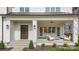 Inviting covered front porch with stylish seating and elegant brickwork at 4021 Nettie Ct # 7, Charlotte, NC 28211