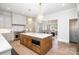 Spacious kitchen features a large island with white countertops, custom cabinets, and modern stainless steel appliances at 4021 Nettie Ct # 7, Charlotte, NC 28211
