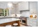 Modern kitchen with a large island, stainless steel range, and bright natural light at 4021 Nettie Ct # 7, Charlotte, NC 28211