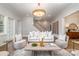 Bright living room with high ceilings, modern furniture, and a staircase at 4021 Nettie Ct # 7, Charlotte, NC 28211