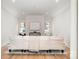 Spacious living area featuring hardwood floors and a modern white sofa, complemented by natural light from the windows at 4021 Nettie Ct # 7, Charlotte, NC 28211