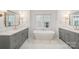 Beautiful main bathroom with dual vanities, a soaking tub, and elegant fixtures for a spa-like experience at 4021 Nettie Ct # 7, Charlotte, NC 28211