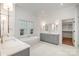 Luxurious main bathroom with dual vanities, a freestanding tub, and a window offering natural light at 4021 Nettie Ct # 7, Charlotte, NC 28211
