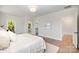 Bright and airy main bedroom showcasing hardwood flooring, neutral tones, and ensuite bathroom at 4021 Nettie Ct # 7, Charlotte, NC 28211