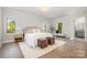 Sunlit main bedroom features hardwood flooring, neutral decor, and windows offering peaceful outdoor views at 4021 Nettie Ct # 7, Charlotte, NC 28211