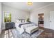 Inviting main bedroom with natural light, a cozy bench, and access to the ensuite bathroom at 4021 Nettie Ct # 7, Charlotte, NC 28211