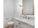 Powder room featuring vanity, granite countertop, modern lighting, and decorative mirror at 4021 Nettie Ct # 7, Charlotte, NC 28211