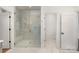 Bright and modern marble shower with glass enclosure, bench seat, and a view into the water closet at 4021 Nettie Ct # 7, Charlotte, NC 28211