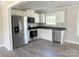 This kitchen features stainless steel appliances, white cabinets, and dark countertops, providing a modern aesthetic at 4044 Hurley Walters Rd, Lancaster, SC 29720