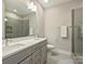 Bathroom with double vanity, walk-in shower, and tiled floor at 520 Sedgefield Park Dr, Charlotte, NC 28203
