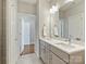 Bathroom featuring a double vanity and a doorway leading to another room at 520 Sedgefield Park Dr, Charlotte, NC 28203